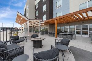 a patio with chairs and tables in a building at TownePlace Suites by Marriott White Hall in White Hall