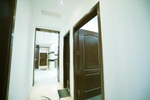 a hallway with a door and a mirror at Entire Super Luxury 3 bedroom in Gr Noida near expo mart in Greater Noida