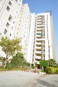 a large white building with trees in front of it at Entire Super Luxury 3 bedroom in Gr Noida near expo mart in Greater Noida