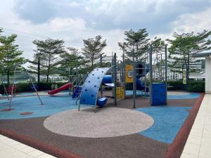 a playground with a slide and swings at Cozy Studio Sk 1 Residence for 4 pax UPM Mines Serdang in Seri Kembangan