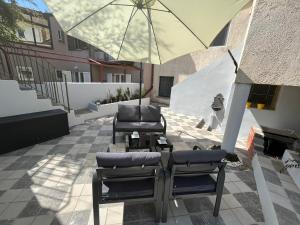 a patio with two chairs and an umbrella at Apartman 39 in Pula
