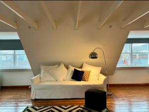 a white couch in a room with windows at Charming City Townhouse in Dublin