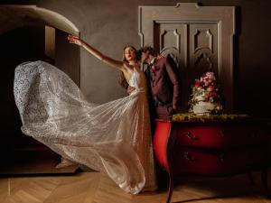a bride and groom standing next to a wedding cake at Paragon 700 Boutique Hotel & SPA in Ostuni