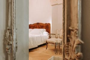 a bedroom with a bed and a mirror at Paragon 700 Boutique Hotel & SPA in Ostuni