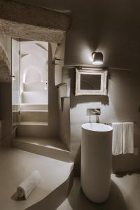 a bathroom with a white sink and a mirror at Paragon 700 Boutique Hotel & SPA in Ostuni