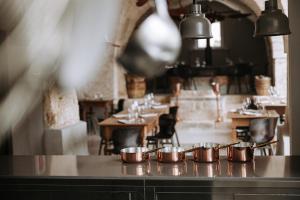 a row of pots on a counter in a restaurant at Paragon 700 Boutique Hotel & SPA in Ostuni