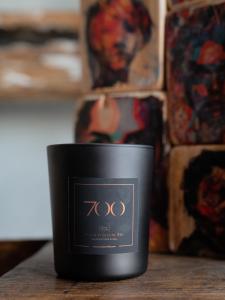 a candle sitting on top of a wooden table at Paragon 700 Boutique Hotel & SPA in Ostuni