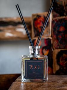 a glass bottle with two chopsticks in it on a table at Paragon 700 Boutique Hotel & SPA in Ostuni