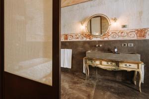 a bathroom with a sink and a mirror at Paragon 700 Boutique Hotel & SPA in Ostuni