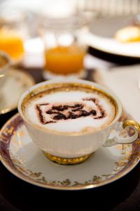 a cup of coffee on a plate on a table at Paragon 700 Boutique Hotel & SPA in Ostuni