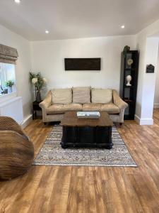 a living room with a couch and a coffee table at Newly renovated Stables conversion in Burstwick