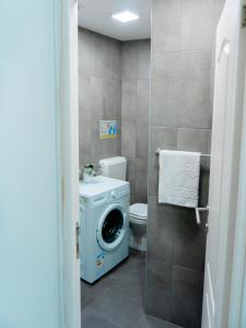 een badkamer met een wasmachine en een wasmachine bij Comfortable Apartment Unirii Square - CAL3B in Boekarest