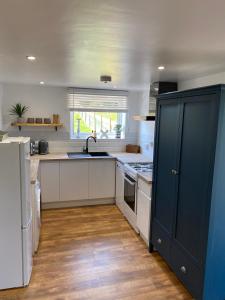 a kitchen with a sink and a stove top oven at Newly renovated Stables conversion in Burstwick +33 photos
