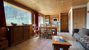 a living room with a couch and a table at L'ourson in Le Grand-Bornand