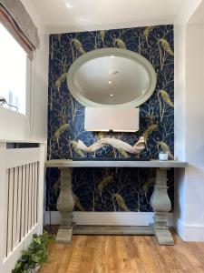 a bathroom with a sink and a mirror on a wall at Newly renovated Stables conversion in Burstwick