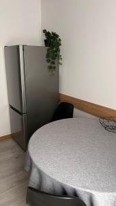 a kitchen with a table and a refrigerator at AA Apartment in Ventspils