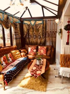 ein Wohnzimmer mit Ledersofas und einem Tisch in der Unterkunft Cheerful 4 bedroom house with garden free parking in London