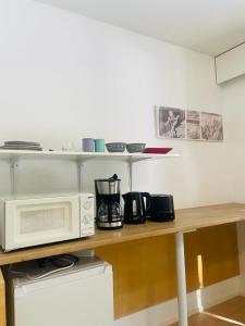a kitchen with a counter with a microwave on it at Voionmaa Voionmajoitus in Ylöjärvi