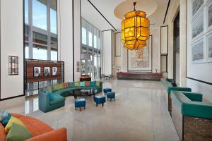 a lobby with a couch and chairs and a chandelier at Assila, a Luxury Collection Hotel, Jeddah in Jeddah