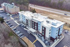 an aerial view of a building with a parking lot at TownePlace Suites by Marriott Raleigh - University Area in Raleigh