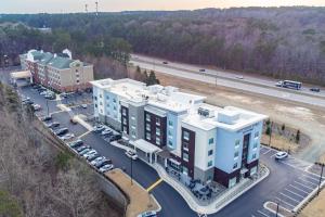an aerial view of a building in a parking lot at TownePlace Suites by Marriott Raleigh - University Area in Raleigh