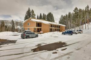 a building with cars parked in the snow at Winter Park Condo Rental about 2 Mi to Ski Resort! in Winter Park