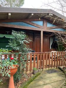 a house with a wooden fence and a porch at Parco delle stelle in Castel del Monte