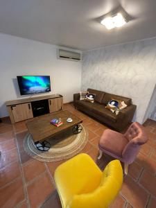 sala de estar con 2 sofás y TV en Villa de charme, en Urtaca