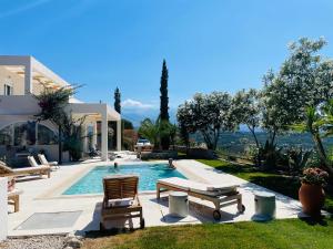 a backyard with a swimming pool and a house at SHIGAYA Boutique Villa in Plaka