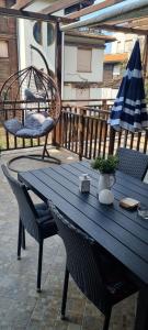 a blue table and chairs and an umbrella on a patio at Eve Santa Marina Studios - sea, pools, relax in Sozopol