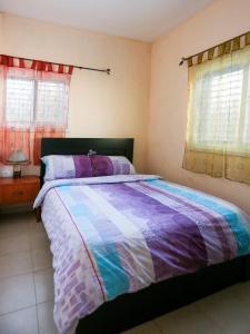 a bedroom with a large bed with a colorful comforter at Apartments Petah Tiqwa in Petaẖ Tiqwa