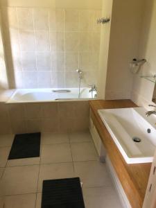 a bathroom with a tub and a sink at Le Lodge Saissac in Saissac