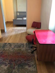 a room with a desk and a chair and a bed at Le Lodge Saissac in Saissac