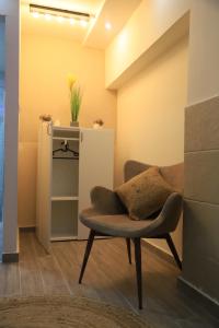 a living room with a chair and a cabinet at Marina room in ‘Akko