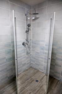 a shower with a glass door in a bathroom at Marina room in ‘Akko