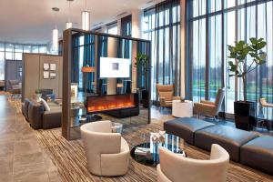 a lobby with couches and a fireplace and windows at AC Hotel Columbus Dublin in Dublin