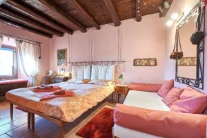 a bedroom with a bed and a couch at B&B Adelche in San Giovanni Bianco