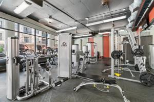 a gym with several treadmills and ellipticals at Lodgeur at Elan Med Center in Houston