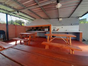 a room with benches and tables in a building at Complejo EQUE PORA in Federación