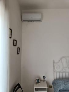 a bedroom with a bed and a air conditioner at Villa Carmela Capotosto in Mondragone