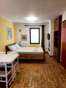 a bedroom with a bed and a table and a window at Terra Apartments in Piran