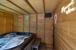 a jacuzzi tub in a wooden cabin at Perfect couple retreat to unwind&relax with HotTub in Peacehaven