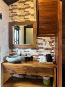 ein Bad mit einem Waschbecken und einem Spiegel in der Unterkunft Vila Kopi Ciwidey in Ciwidey