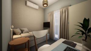 a living room with a couch and a table with a laptop at Gest in Mellieħa