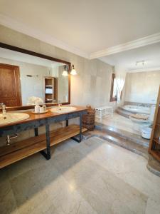 a large bathroom with two sinks and a large mirror at Son Apiana in Mancor del Valle