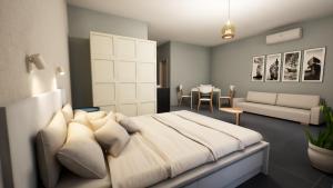 a bedroom with a large bed and a living room at Gest in Mellieħa