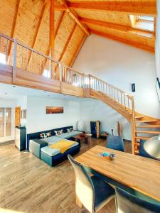 a living room with a bed and a staircase at Ferienhaus Britta Kietzmann in Feldberg