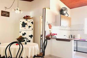 a kitchen with a table and a refrigerator at Grandiosa Casa-Jacuzzi Privado in Flandes