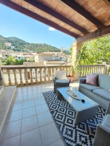 a patio with couches and a table on a balcony at Son Apiana in Mancor del Valle