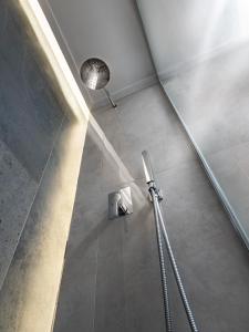 een douchecabine in een badkamer met een licht bij The H Experience - Stylish 2BD apt with balcony in Heraklion center in Heraklion